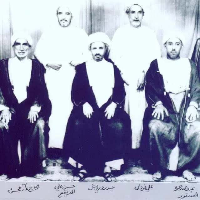 Haider Darwish, seated in the centre, with his peers. Each name is written under the man.
